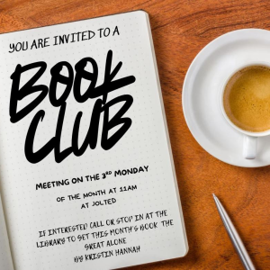 a book, pen, and cup of coffee