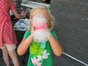 girl blowing bubbles