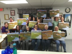 patrons displaying their paintings